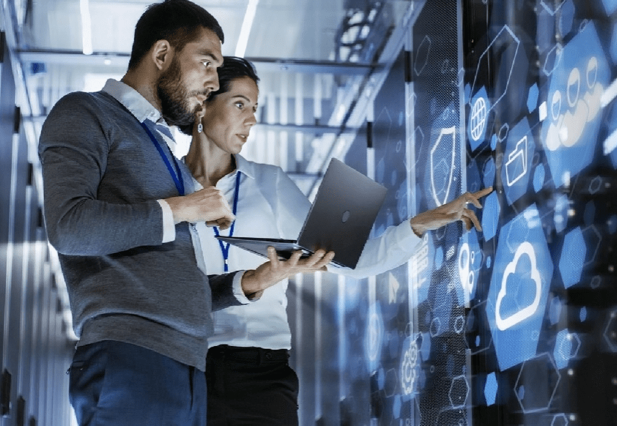 Two men are looking at a computer screen.